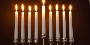 Silver Hanukkah candles all candle lite on the traditional Hanukkah menorah